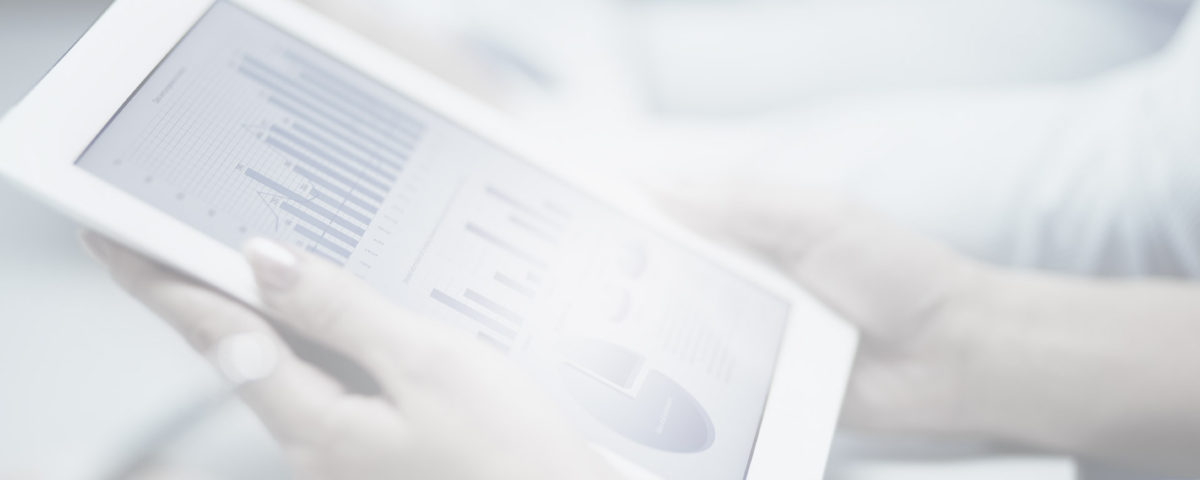 A close up of a tablet with graphs on it